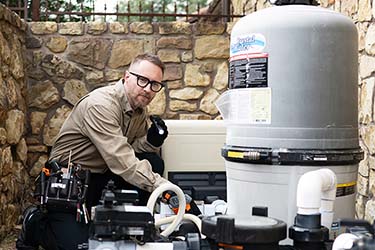 Calvin Peterson, licensed home inspector, inspecting pool pump equipment.