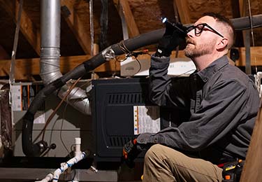 Calvin Peterson, Texas home inspector from Fort Worth, inspecting an attic.